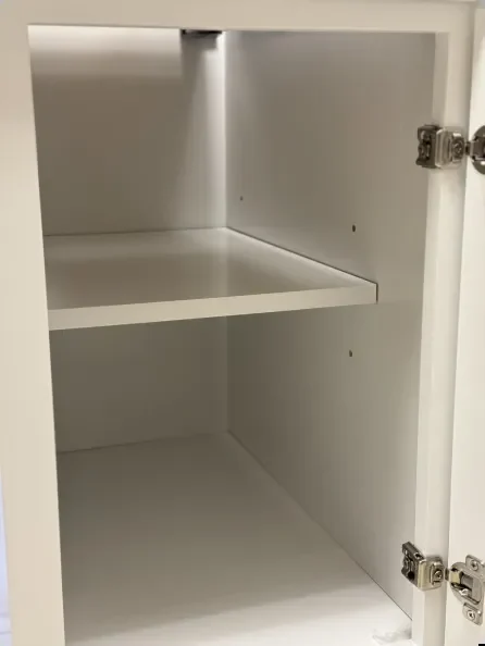 Open cabinet interior with a shelf, back, and concealed hinges